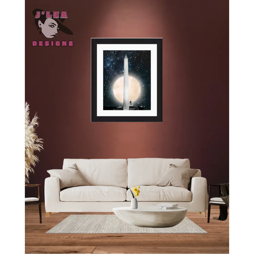 Framed artwork of a moonlit scene with a tall structure, displayed above a beige sofa in a living room.