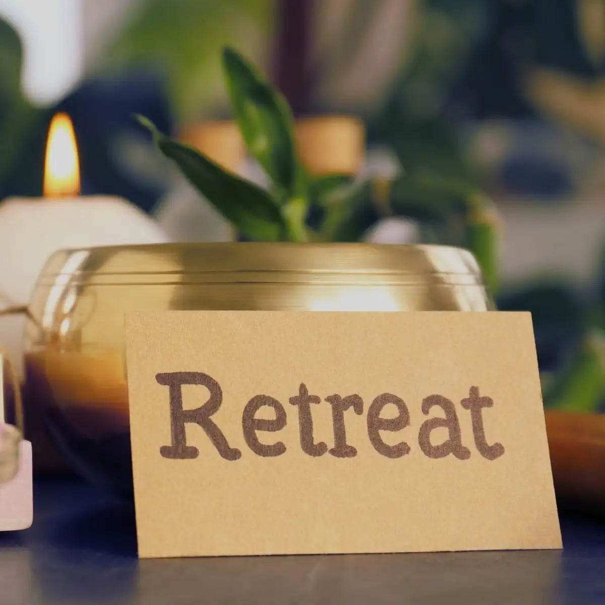 Note with 'Retreat' text in front of a candle and plant, suggesting relaxation.