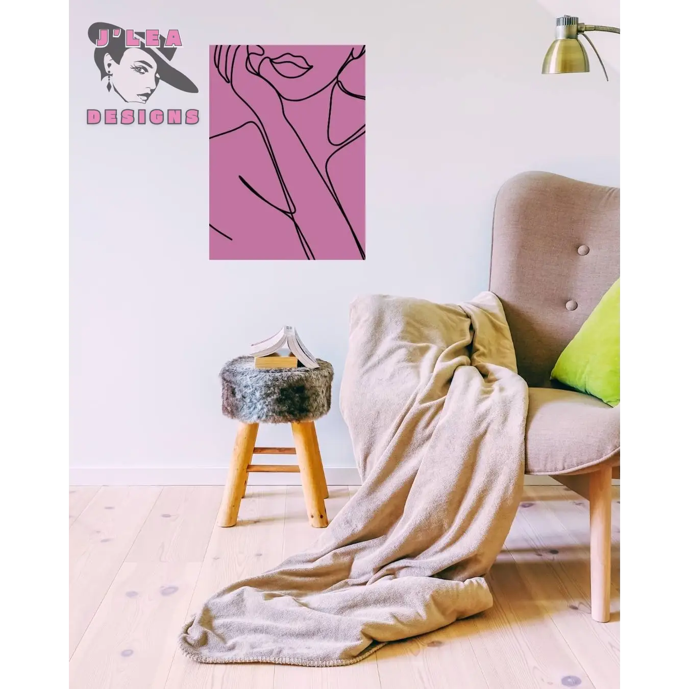 Beige armchair with a blanket draped over it, pink abstract art on the wall, and a small stool.