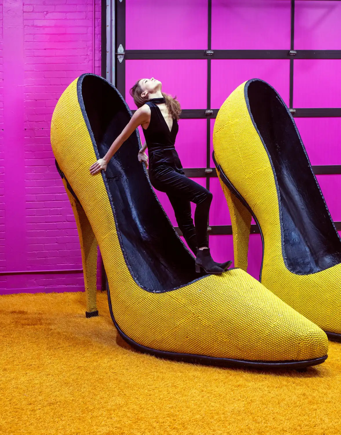 A pair of yellow high-heeled shoes with black interiors